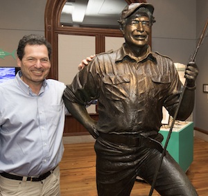 John Hemingway poses with a statue of his grandfather, cast in bronze. Image: Rob O'Neal